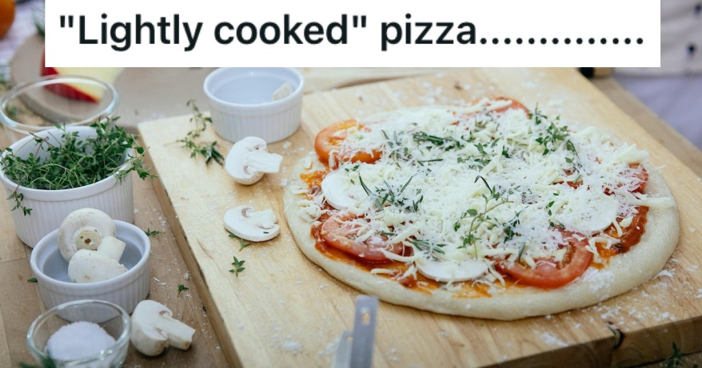 An uncooked pizza on a board