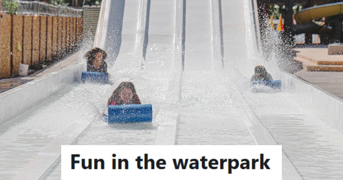 Kids having fun going down a waterslide at a waterpark