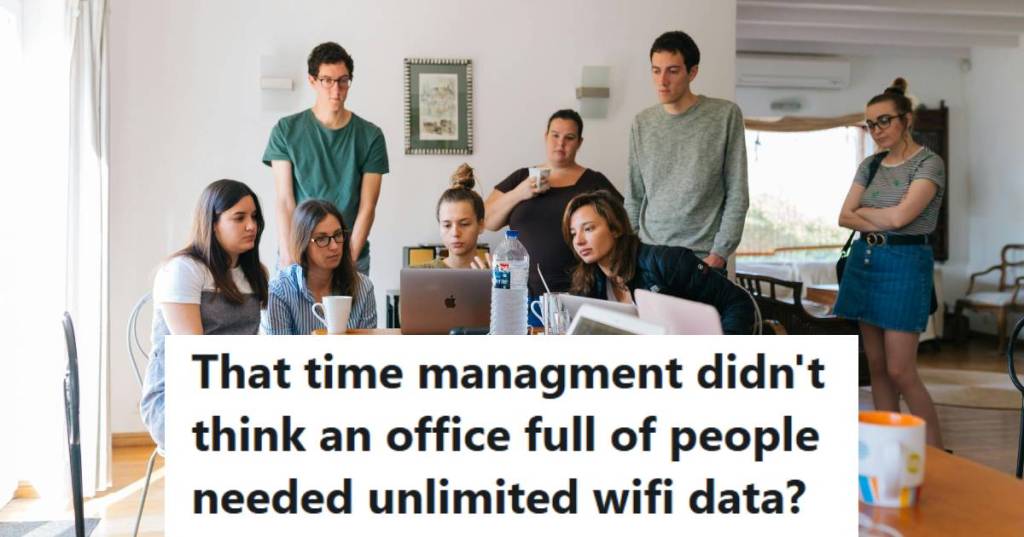 Group of coworkers standing around one laptop