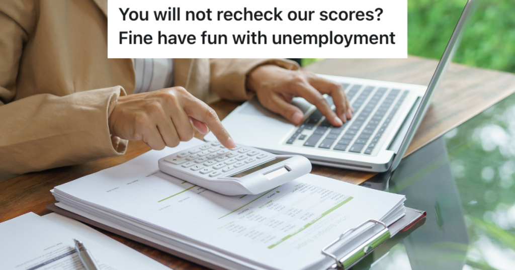 Person with computer and calculator sitting at desk.