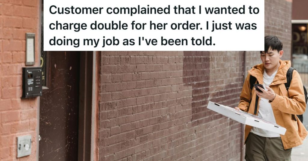 Pizza delivery guy holding a box while looking at his phone