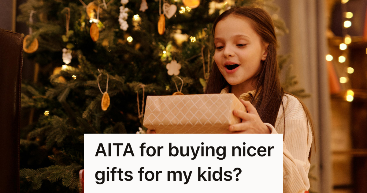 little girl opening a present under the christmas tree