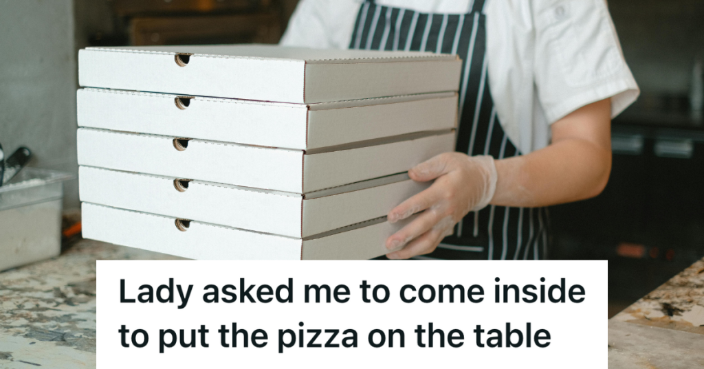 man in apron holding a stack of pizza boxes