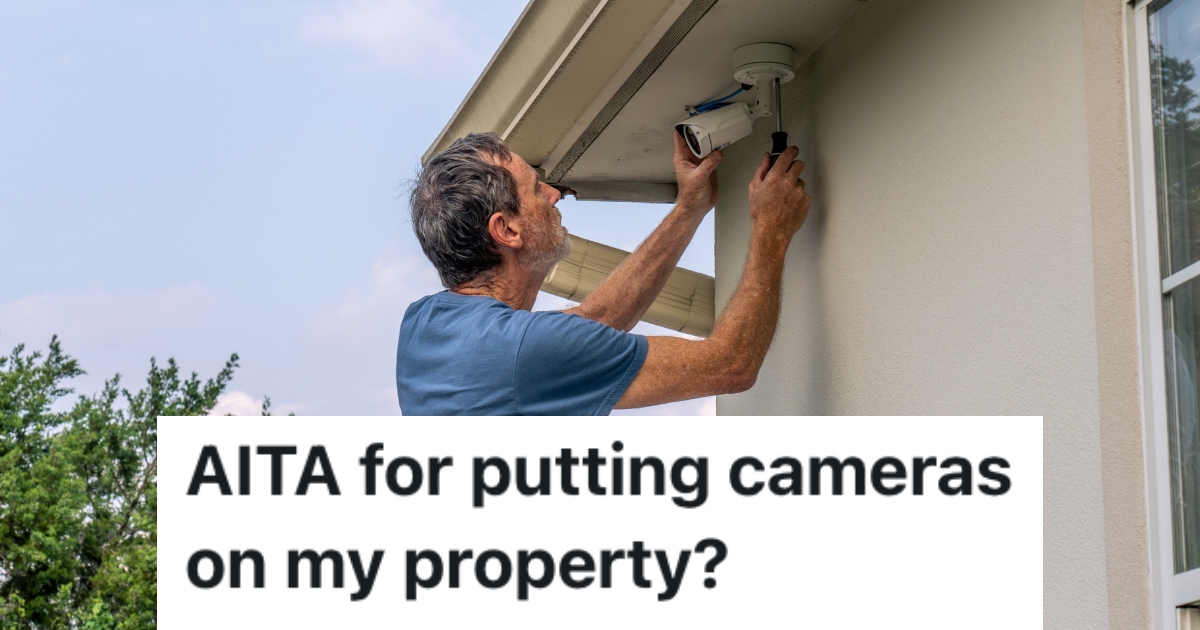 man putting up security camera