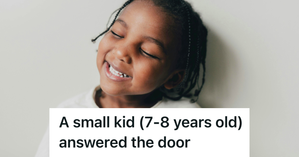 smiling kid in front of white wall