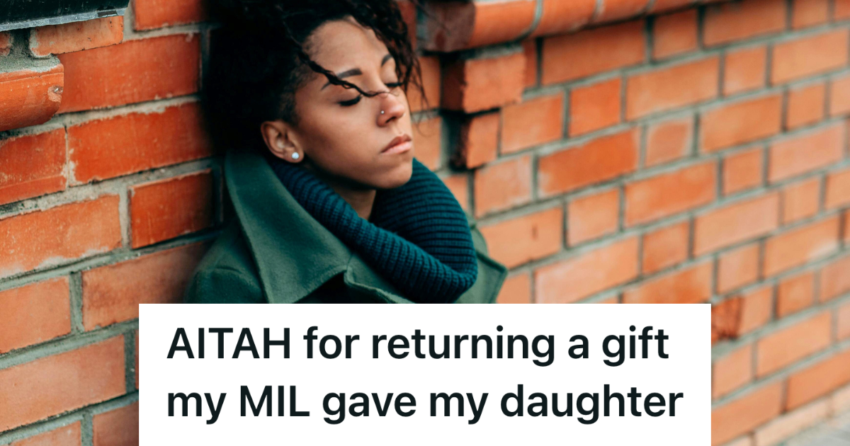 stressed woman in green coat leaning against the wall