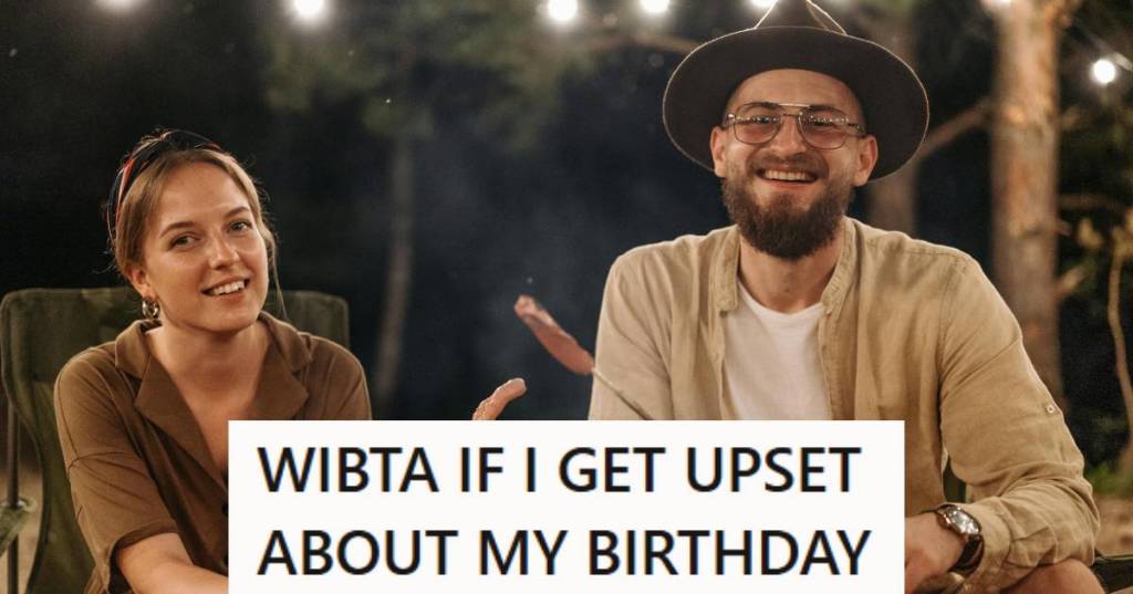 Man and woman sitting by a campfire smiling and eating food