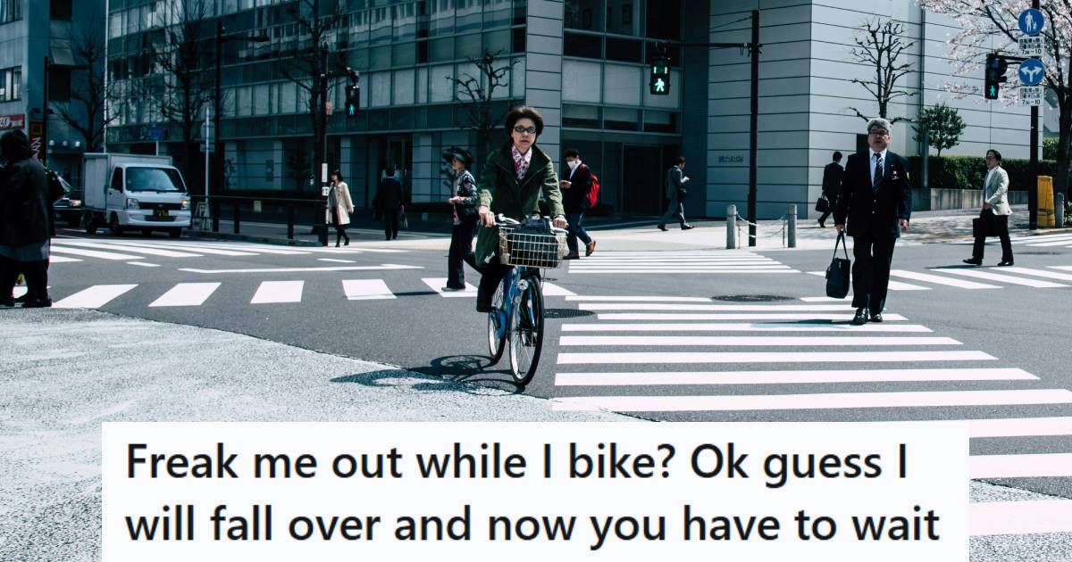 Person riding a bike through a very large intersection