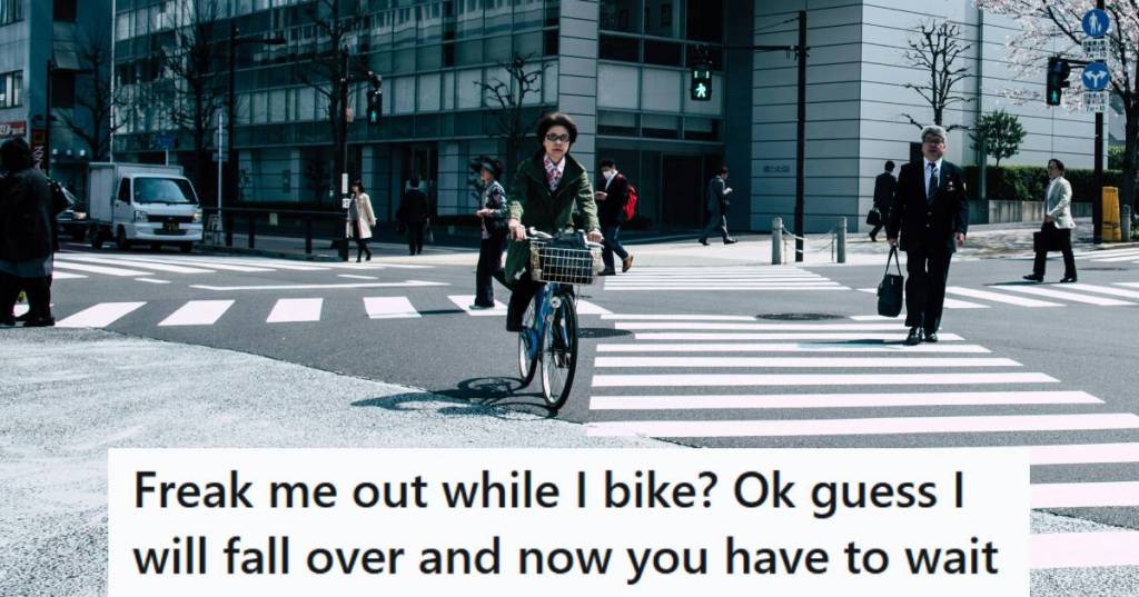 Person riding a bike through a very large intersection