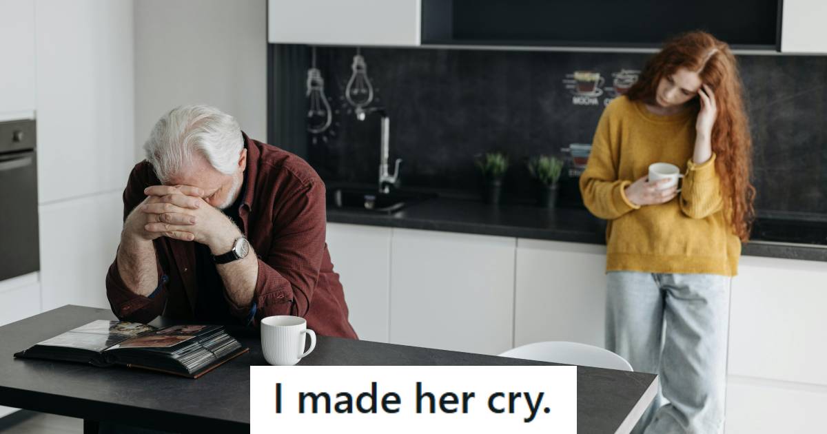 Man sitting at the table in the break room feeling bad he made her cry