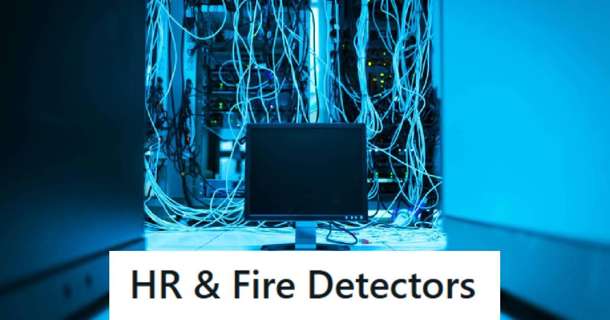 Computer sitting in a blue room with lots of wires and stuff in the background