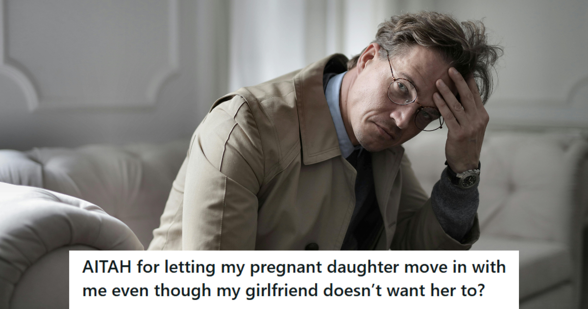 Man in beige coat looking stressed