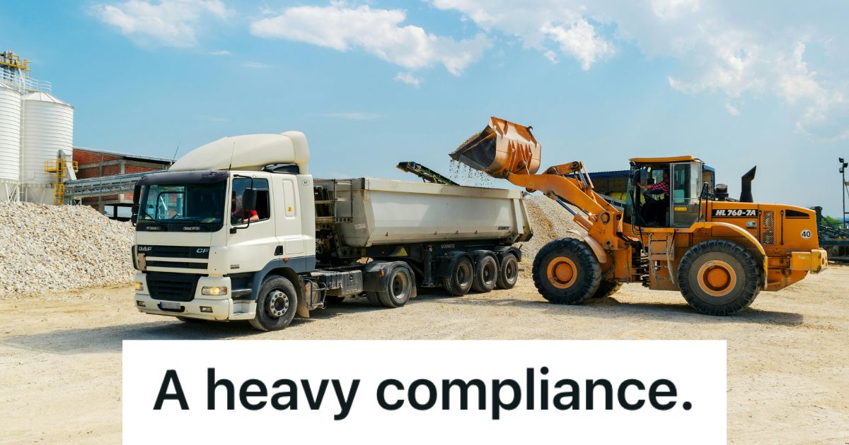 Loader machine loading a white truck