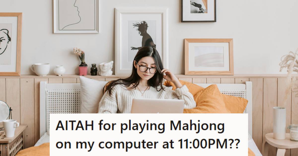 Woman sitting on her bed playing Mahjong on her Apple Laptop