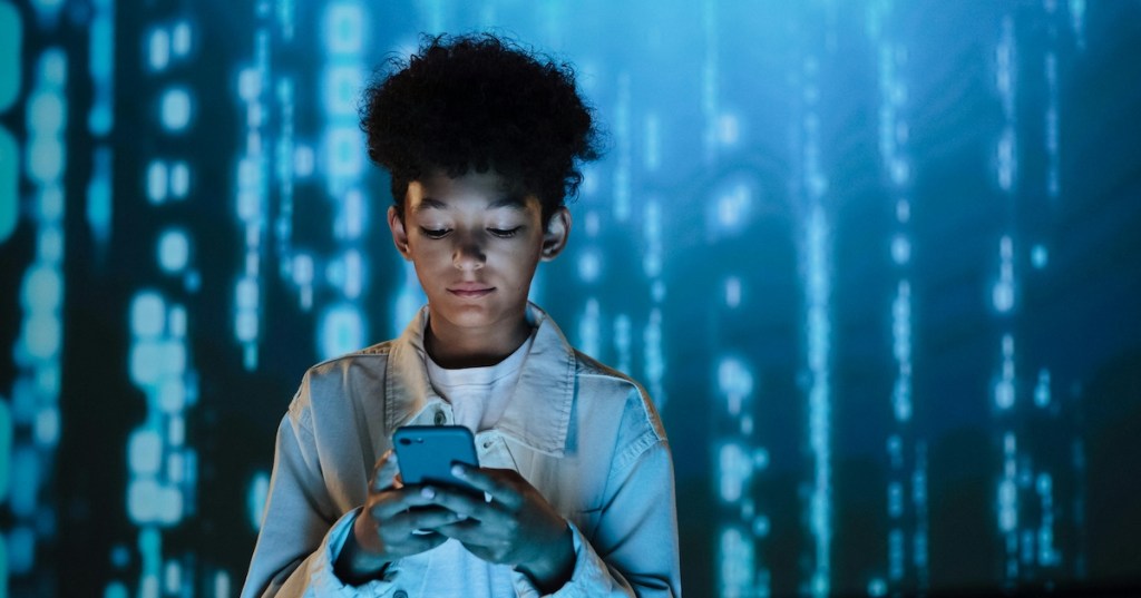 A boy using a mobile phone