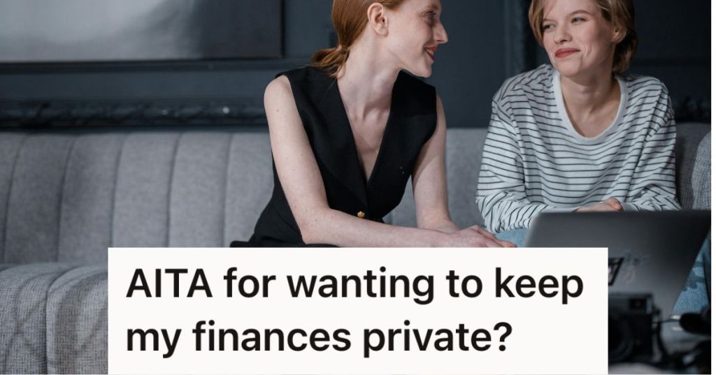 Two women sitting on the couch looking at a laptop