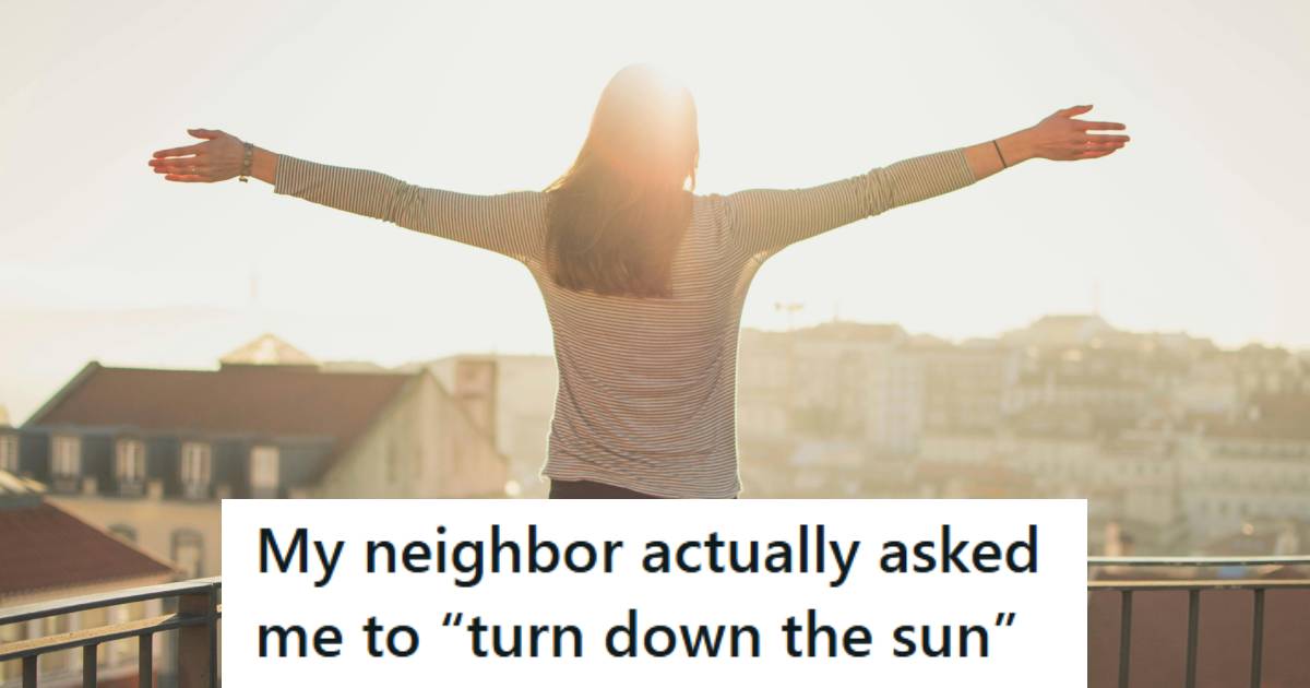 Woman standing on a porch with her hands raised, taking in the sunlight