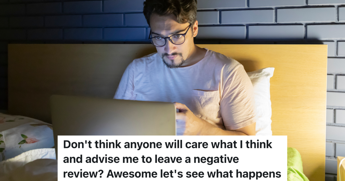 man sitting in bed staring at a laptop screen