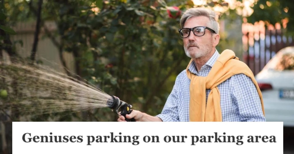 Old man watering the plants with a hose