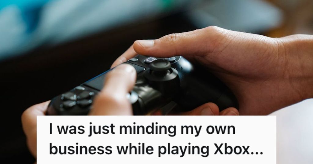 Man holding a console controller and playing video games