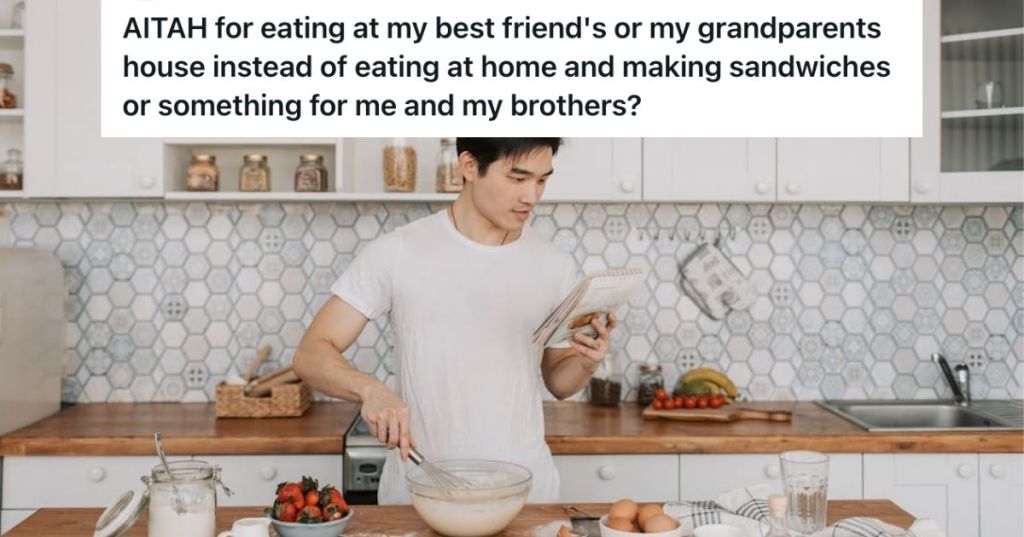Young man making pancakes while looking at his recipe notes