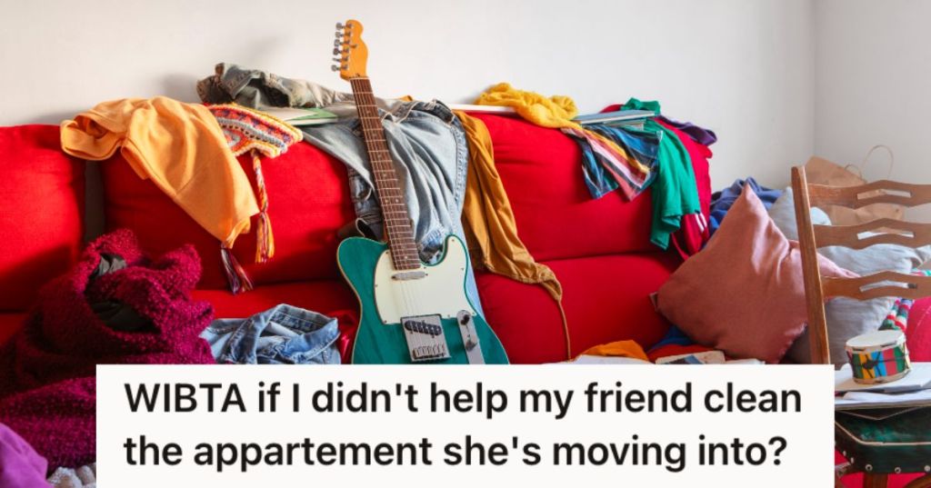 A messy apartment with clothes and a guitar on the couch