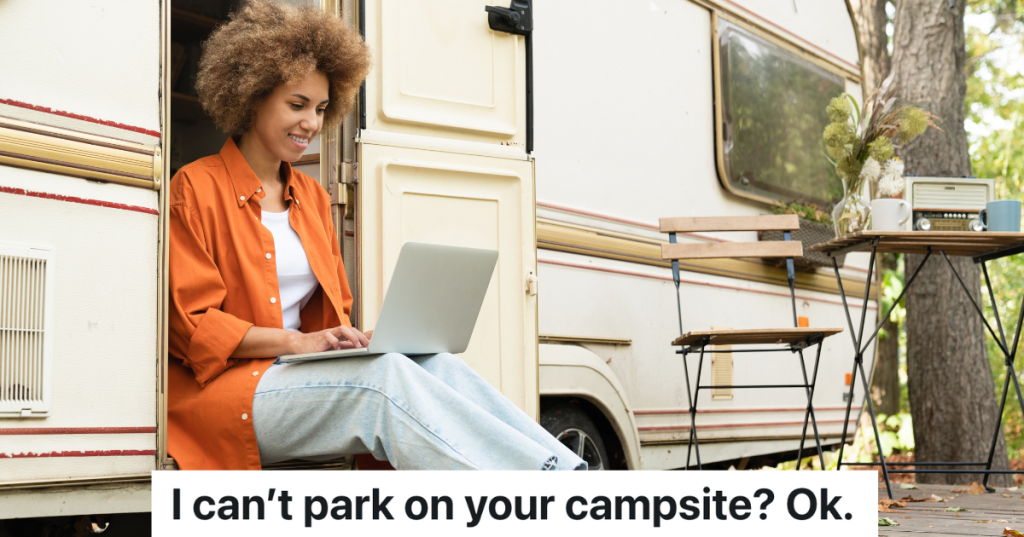 woman sitting in the doorway of a camper with her laptop