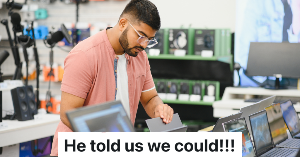 man shopping in the electronics department of a store