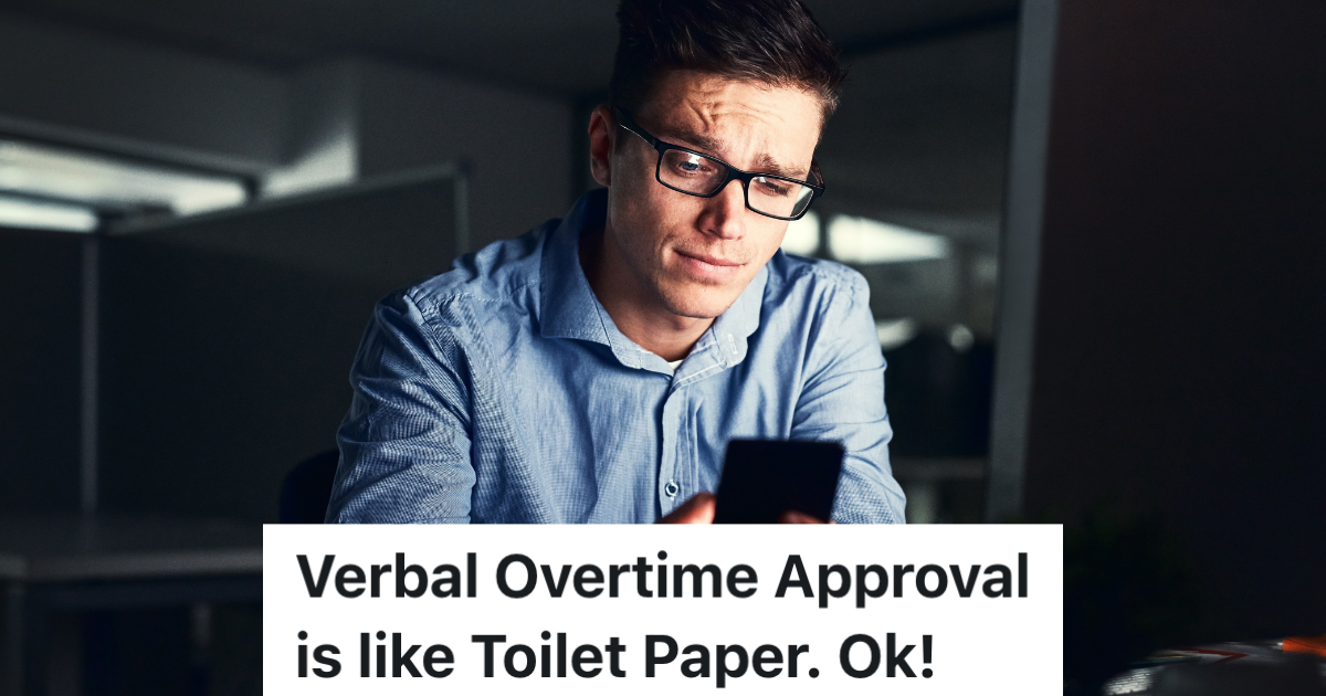 man looking at his phone in an office at night