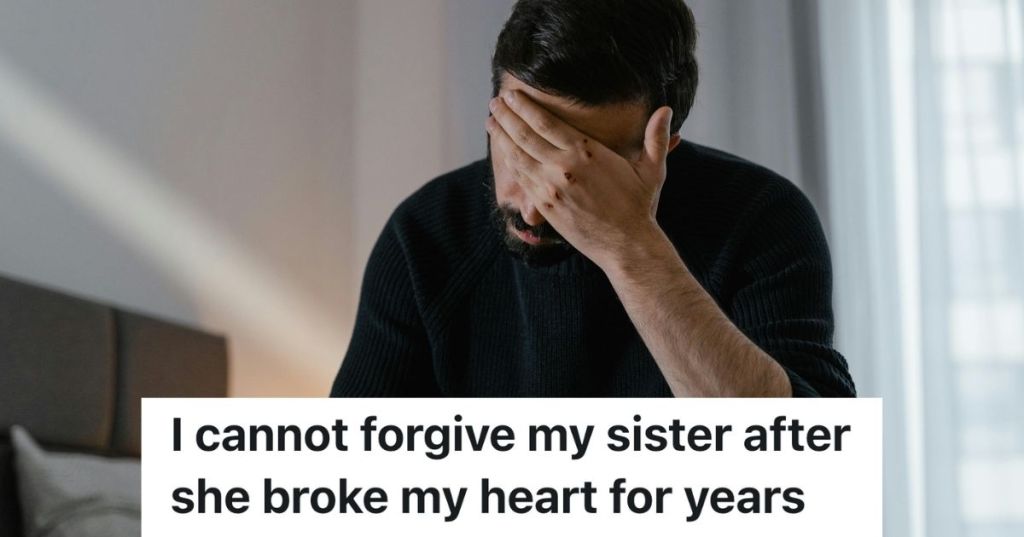 Man hunched over with his hand on his head