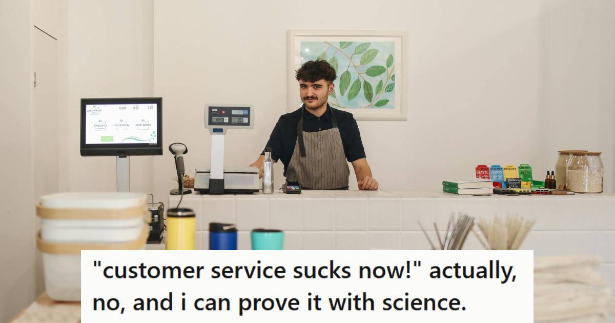 Cashier smiling behind the counter because he just came up with a good plan