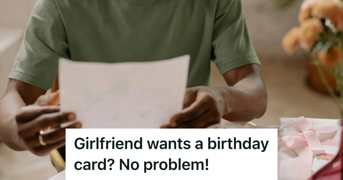 man in green shirt holding big piece of paper