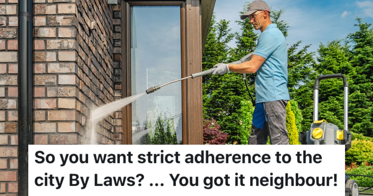 man pressure washing a house