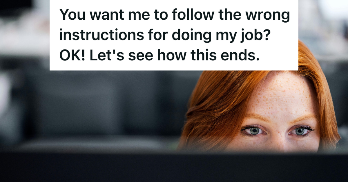 red headed woman looking over her computer screen