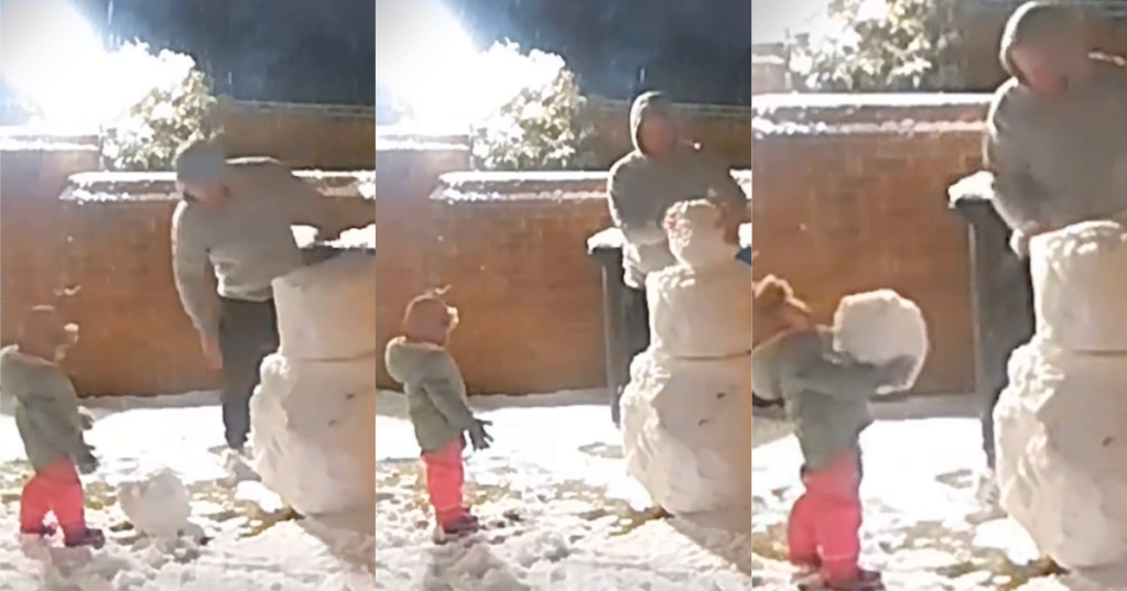 man and child making a snowman