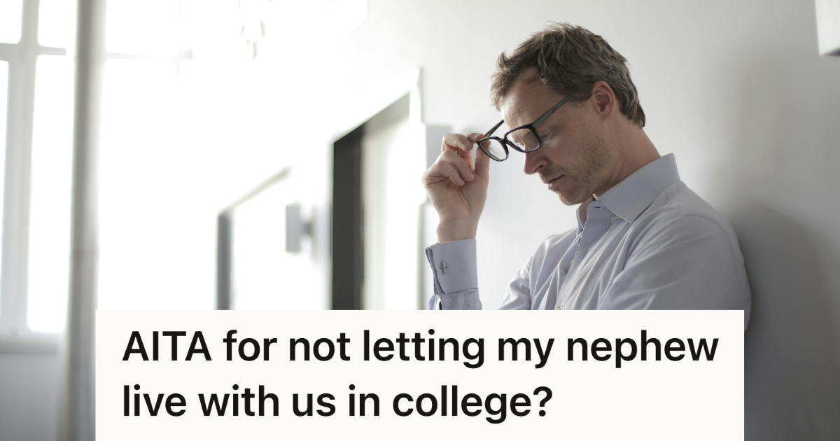 stressed man in glasses leaning against wall