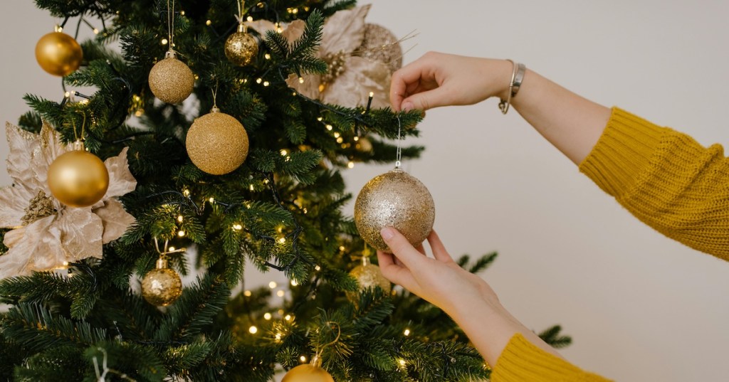 Hanging gold baubles on a Christmas tree