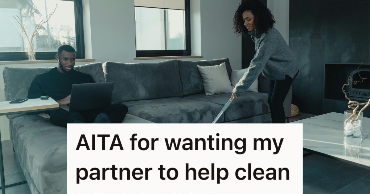 Man sitting on the couch with his laptop while woman mops the floor