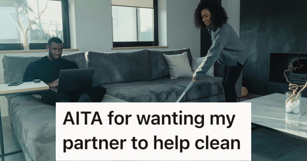 Man sitting on the couch with his laptop while woman mops the floor