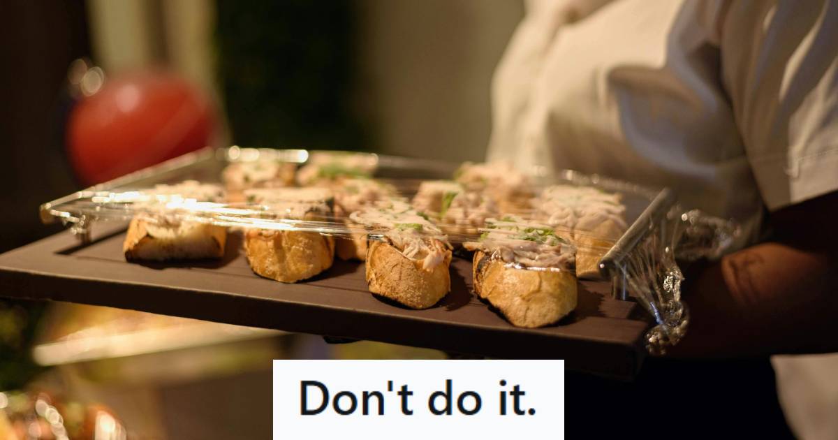 Woman walking through an event carrying catering tray