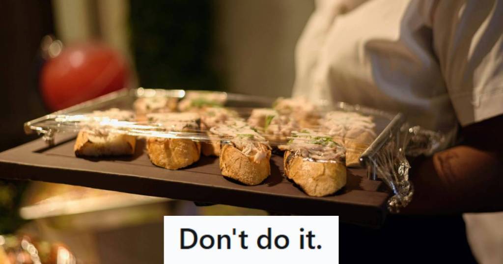 Woman walking through an event carrying catering tray
