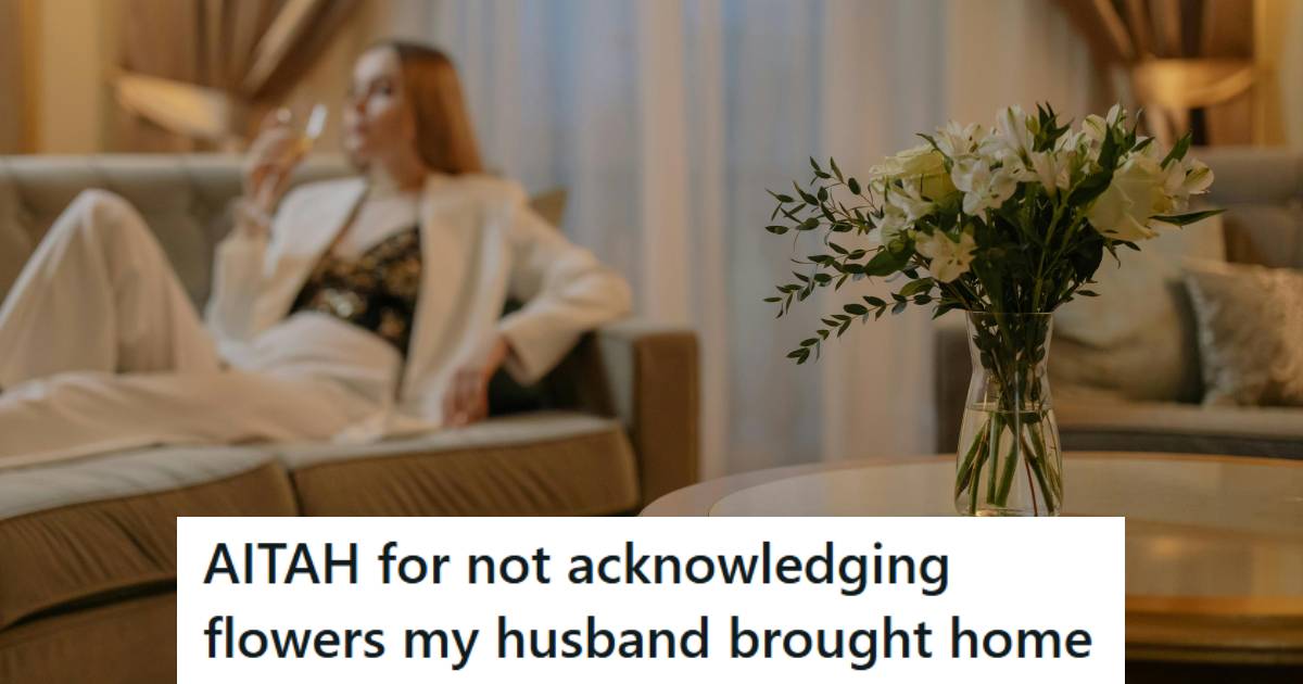 Woman sitting on a couch alone, drinking wine by her flowers