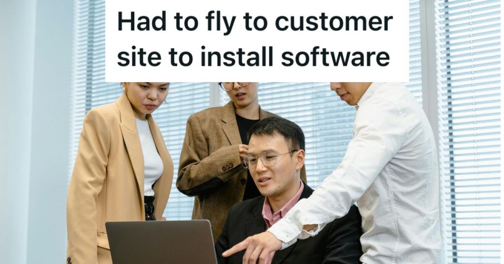 People in an office looking at a laptop