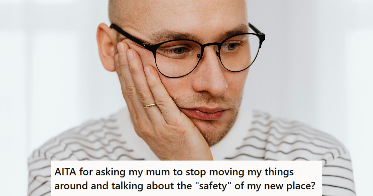 Man in glasses looking down sadly