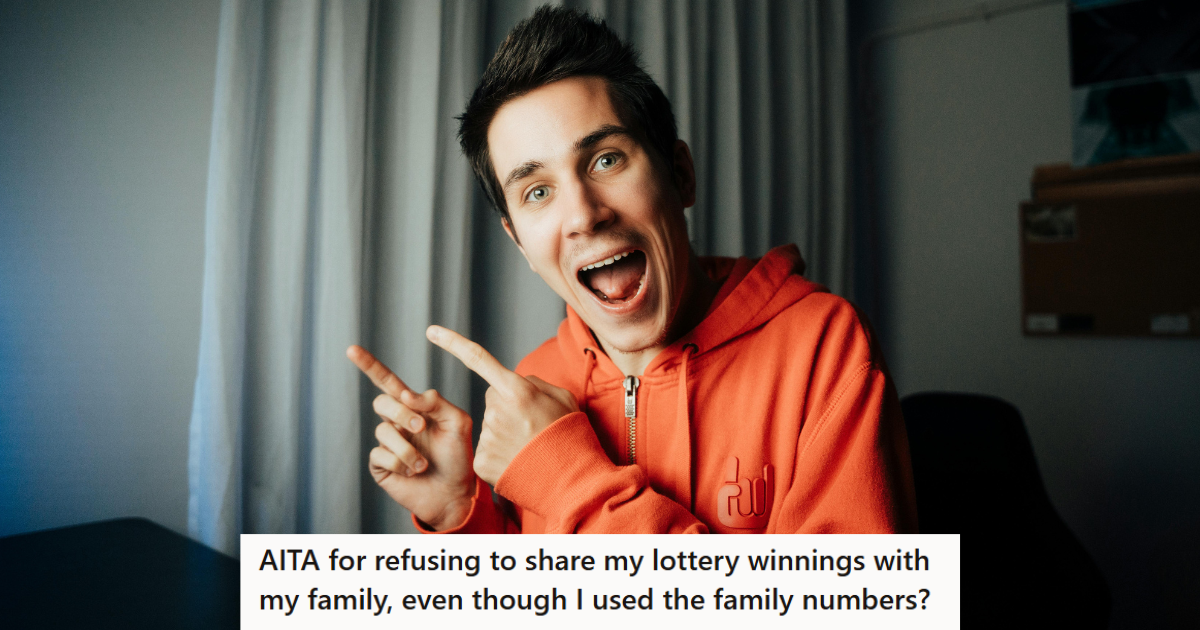 Man in orange hoodie pointing happily