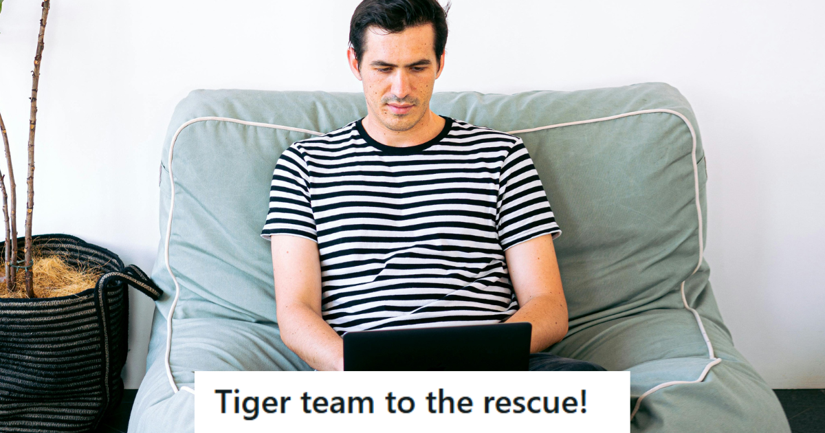 Man in striped shirt working on his laptop