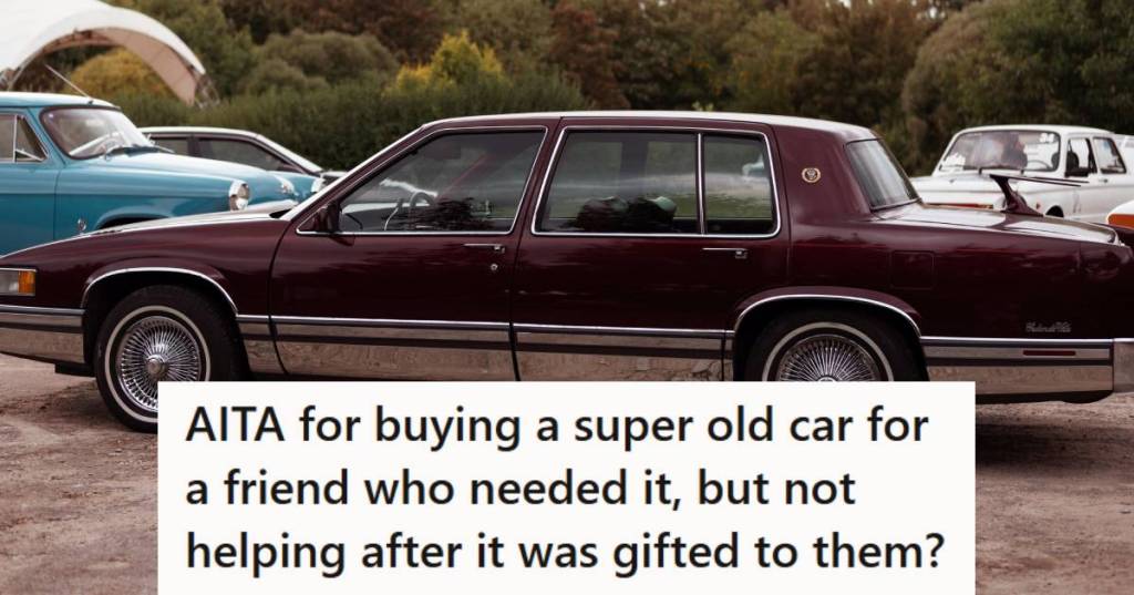 Older model Cadillac Sedan de Ville in maroon, just sitting and waiting