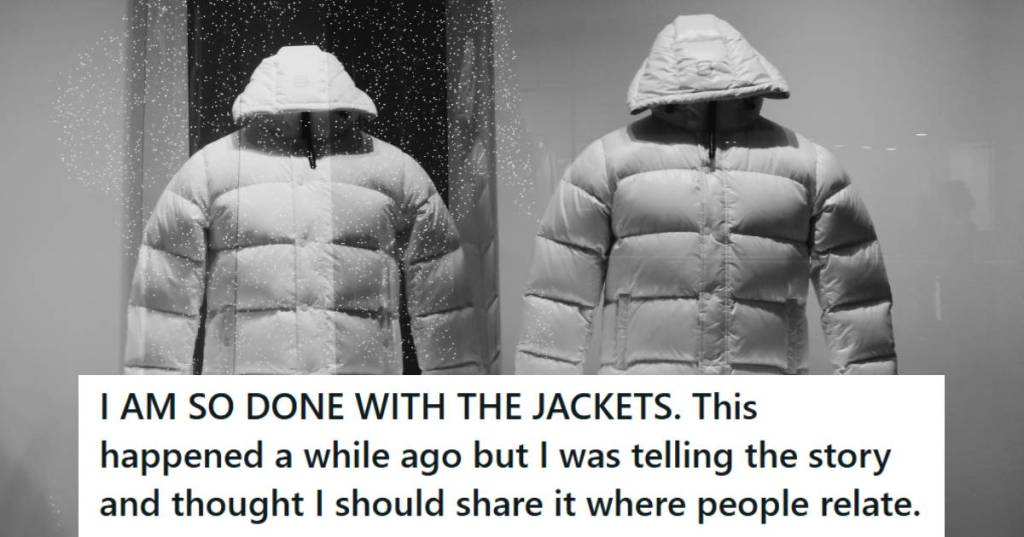 White puffer jackets behind glass in a retail display