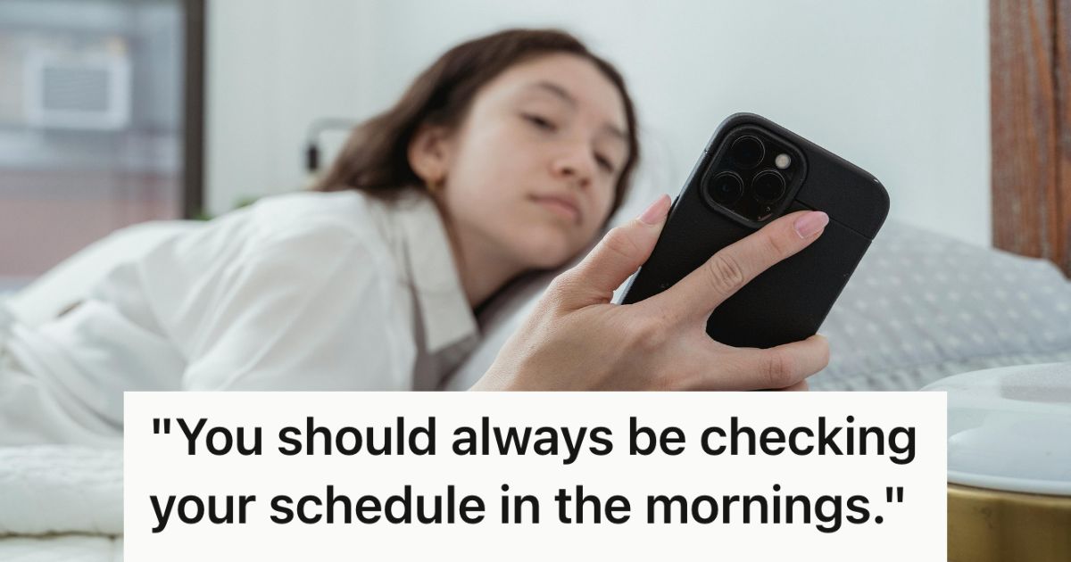 Half-asleep woman checking her phone in bed