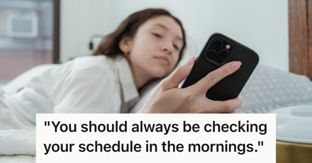 Half-asleep woman checking her phone in bed